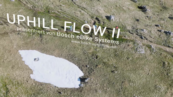 Video-Standbild: Blick von oben auf eine felsige Landschaft, darüber der Text: Uphill Flow 2